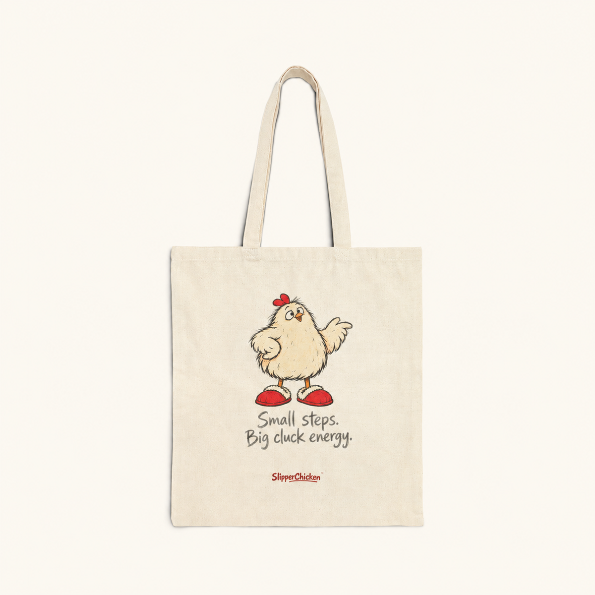 Natural canvas Confident Tote with upright chicken, Small steps. Big cluck energy. in two lines and discreet red SlipperChicken signature, on site tan at actual supplier print proportions.