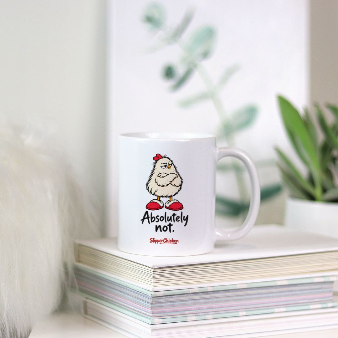 Unimpressed Mug resting on a stack of magazines beside a small plant