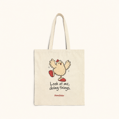Natural canvas Delighted Tote with joyful wings-up chicken, Look at me, doing things. in two lines and a small red SlipperChicken signature, on a warm tan background; supplier print proportions retained.