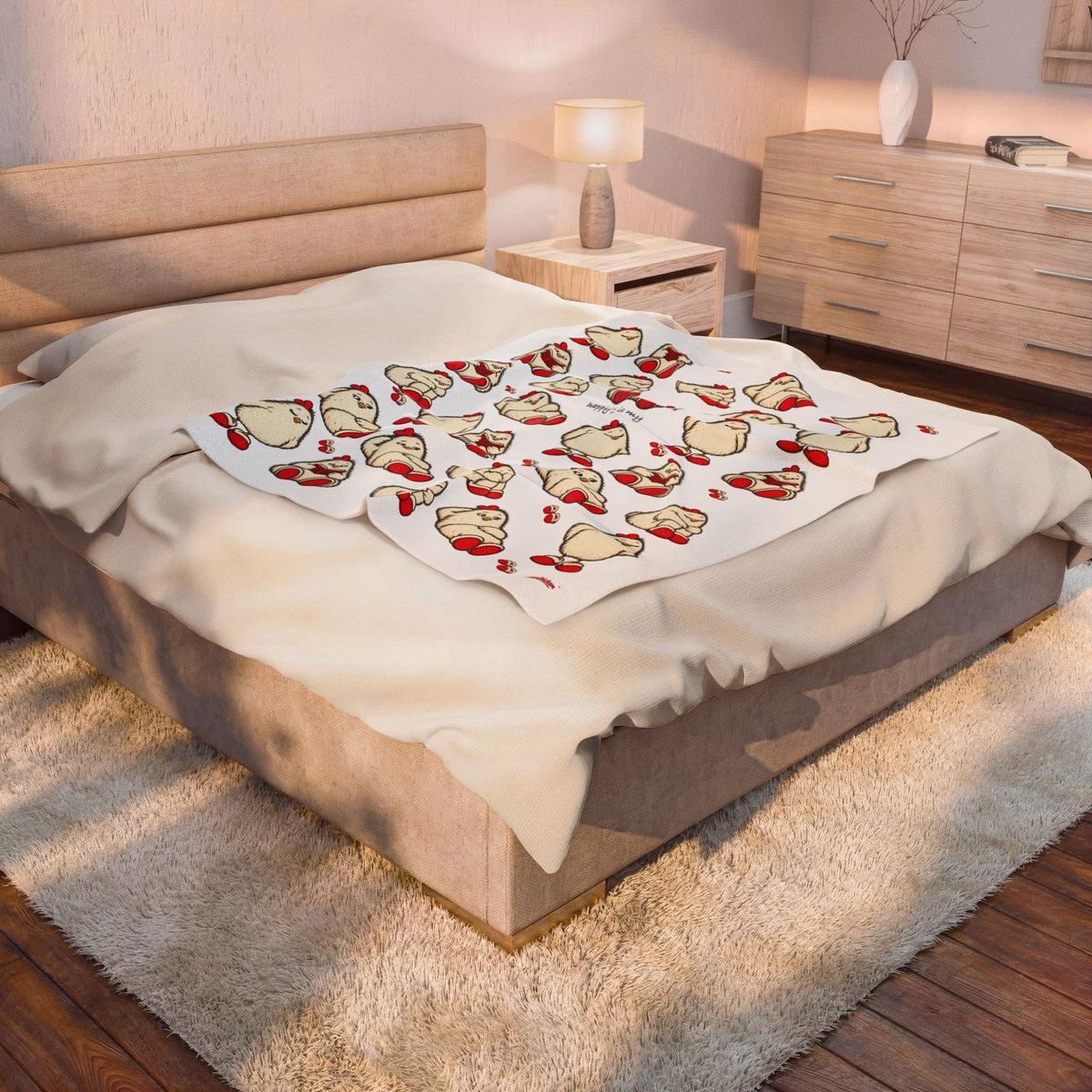 Printify lifestyle mockup of the 50 × 60-inch Content Blanket with focal red-mug chicken and quote across the foot of a bed in a warm neutral bedroom