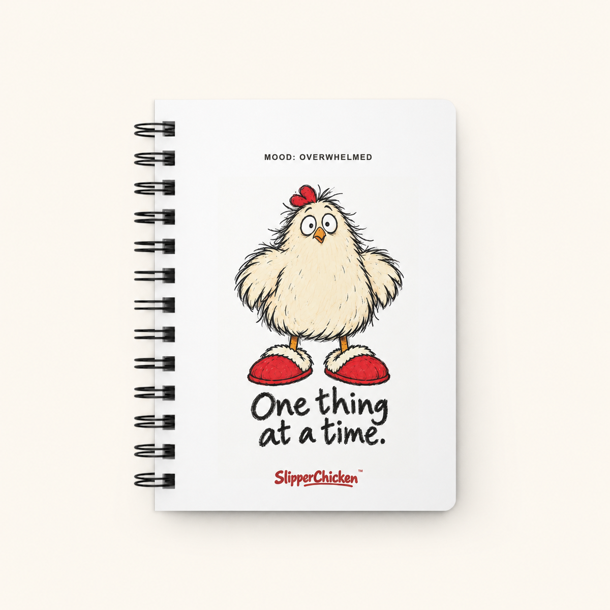 Overwhelmed Journal white front on site tan, with MOOD: OVERWHELMED, frazzled chicken, One thing at a time. quote and SlipperChicken wordmark at actual supplier print scale.